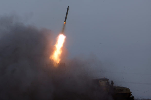 A Ukrainian BM-21 Grad multiple rocket launcher fires a rocket, as Russia's attack on Ukraine continues, during intense shelling on Christmas Day at the frontline in Bakhmut, Ukraine, December 25, 2022. REUTERS/Clodagh Kilcoyne