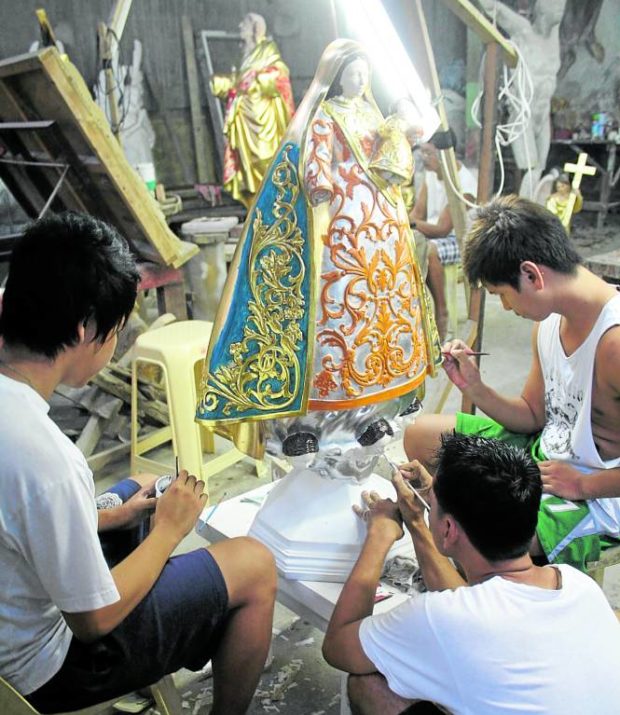  Young men gilding goldfor a technique called “estofado,” making it appear that wooden images wear clothes.