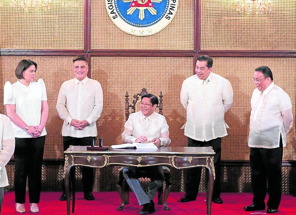 President Marcos looks pleased at the record time that he said Congress had approved the P5.268-trillion national budget for 2023 which he enacted on Friday in ceremonies at Malacañang.