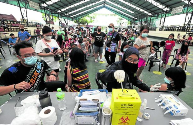 Schoolchildren get vaccination booster shots against COVID-19 at the Baclaran Elementary School in Parañaque City in this file photo. 
