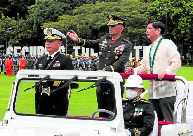 TROOP REVIEW   President Marcos  graces the 87th anniversary of the Armed Forces of the Philippines at Camp Aguinaldo on Monday. —MARIANNE BERMUDEZ