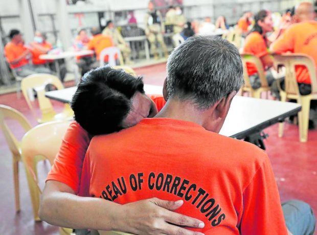 A detainee from the Correctional Institution for Women (CIW) hugs her ailing husband, an inmate of New Bilibid Prison 