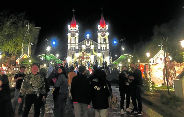 Tourists come up to Baguio for the seasonal cold weather, and the “selfie” opportunities at iconic destinations like Baguio Cathedral, as shown in this photo taken during a night Mass on Dec. 19. STORY: Chill descends upon Baguio as mercury drops to 12.2°C