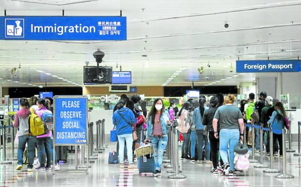 Filipino workers from abroad arrive at Ninoy Aquino International Airport on Dec. 1, as the holiday season’s rush and heavy traffic begin complaint airline overbooking probe