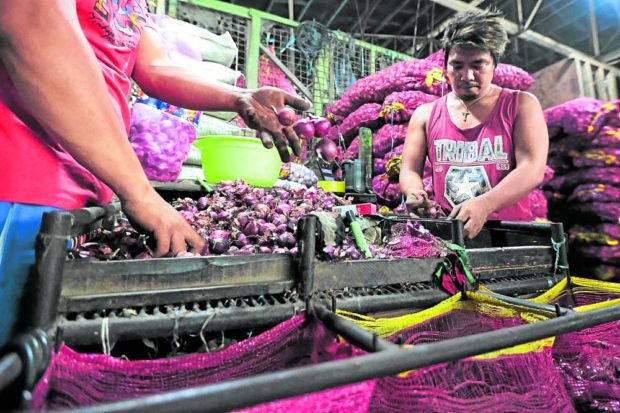 Onion vendors at the Balintawak Public Market in Quezon City. STORY: Senate probe of high onion prices pushed