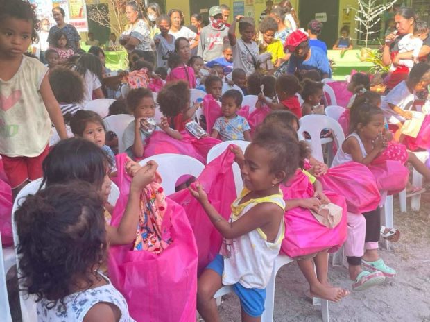Some 200 children in the Aeta village of Sapang Bato in Angeles City on Thursday (Dec. 22) received gift bags of food, toys, clothes and books from employees of the Bases Conversion and Development Authority. (Photo by Tonette Orejas)