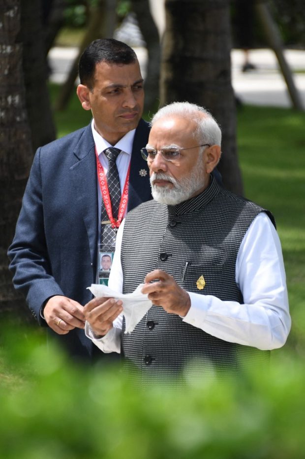 India's Prime Minister Narendra Modi walks to the lunch meeting during the G20 summit in Nusa Dua on the Indonesian resort island of Bali on November 15, 2022. (Photo by SONNY TUMBELAKA / POOL / AFP)