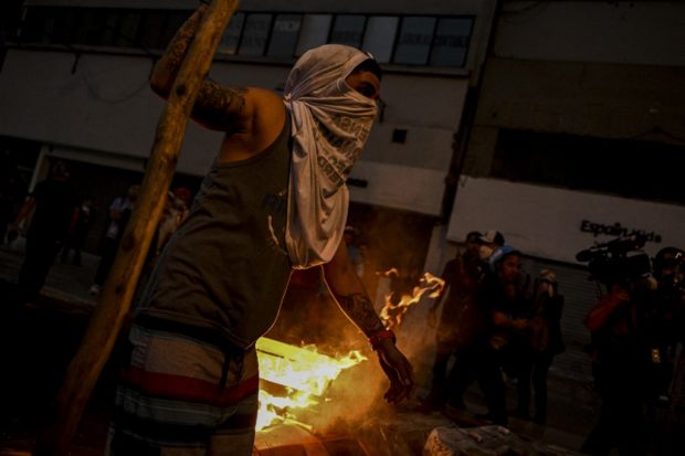 Supporters of Peruvian former President Pedro Castillo clash with riot police during a demonstration demanding his release and the closure of the Peruvian Congress in Lima on December 9, 2022