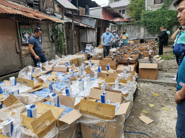 Authorities inventory the contraband cigarettes seized in Digos City on Wednesday. STORY: Over 73,000 packs of contraband cigarettes seized in Digos City