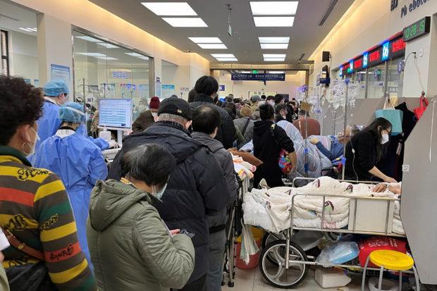 Patients lie on beds next to closed counters at the emergency department of Zhongshan Hospital, amid the coronavirus disease (COVID-19) outbreak in Shanghai, China January 3, 2023. REUTER