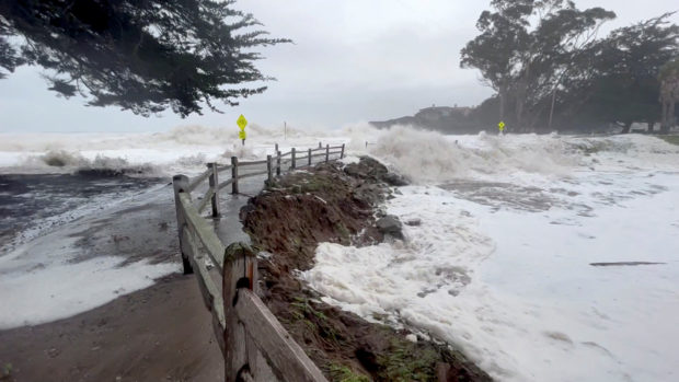 Waves brought by a massive Pacific storm rush ashore in Santa Cruz, California, U.S. January 5, 2023 in this still image obtained from social media video. Dane Nabal/via REUTERS