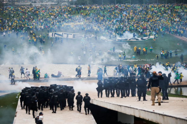Supporters of Brazil's former President Jair Bolsonaro demonstrate against President Luiz Inacio Lula da Silva while security forces operate, outside Brazil’s National Congress in Brasilia, Brazil, January 8, 2023. REUTERS/Adriano Machado