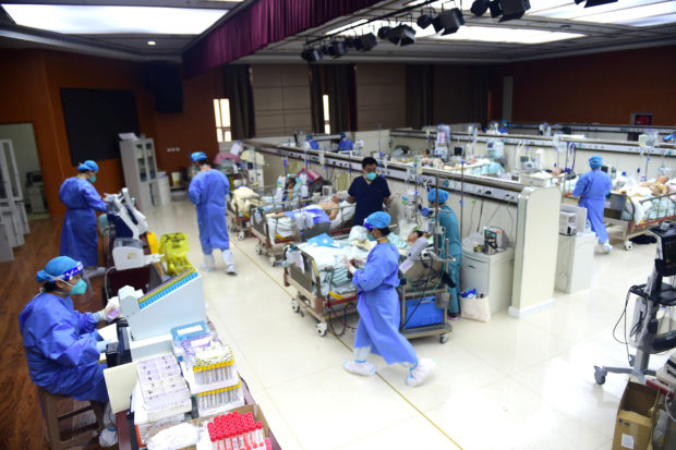 Medical workers attend to patients of the coronavirus disease (COVID-19) at an intensive care unit (ICU) converted from a conference room, at a hospital in Cangzhou, Hebei province, China January 11, 2023. China Daily via REUTERS