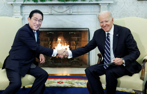 U.S. President Joe Biden shakes hands with Japan's Prime Minister Fumio Kishida during a bilateral meeting in the Oval Office at the White House in Washington, U.S., January 13, 2023. REUTERS/Jonathan Ernst