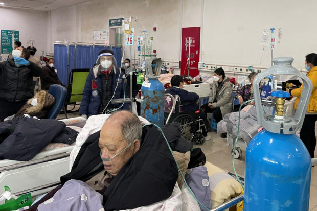 FILE PHOTO: Patients lie on beds in the emergency department of a hospital, amid the coronavirus disease (COVID-19) outbreak in Shanghai, China, January 5, 2023. REUTERS/Staff/File Photo