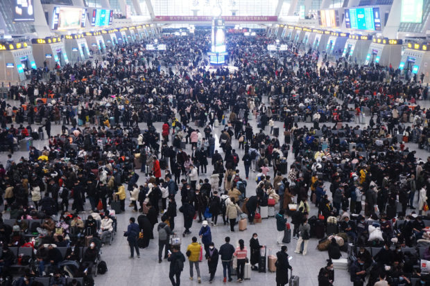 FILE PHOTO: Travellers wait for their trains at Hangzhou East railway station during the Spring Festival travel rush ahead of the Chinese Lunar New Year, in Hangzhou, Zhejiang province, China January 20, 2023. China Daily via REUTERS