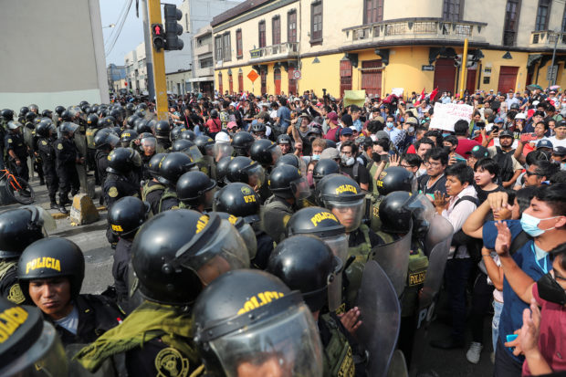 Police officers stand guard, as anti-government protesters demand the release of protesters detained in the protests, after President Pedro Castillo was ousted, in Lima, Peru January 21, 2023. REUTERS/Sebastian Castaneda