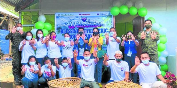 Officials of the military and other government agencies join former NPA guerrillas who ventured into turmeric herbal drink production, during the blessing of their facility in Imelda,Zamboanga Sibugay, in August 2021. STORY: In Zamboanga Sibugay, brew comes out of rebel lairs