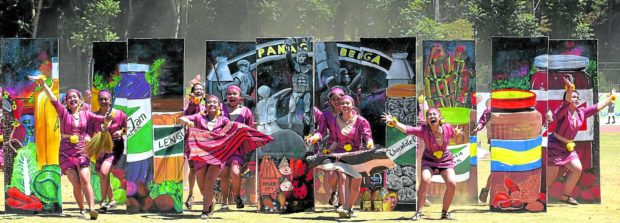 With images of Baguio City’s famous products as their backdrop, a group of street dancers performs during the 2019 staging of Panagbenga (Baguio Flower Festival)