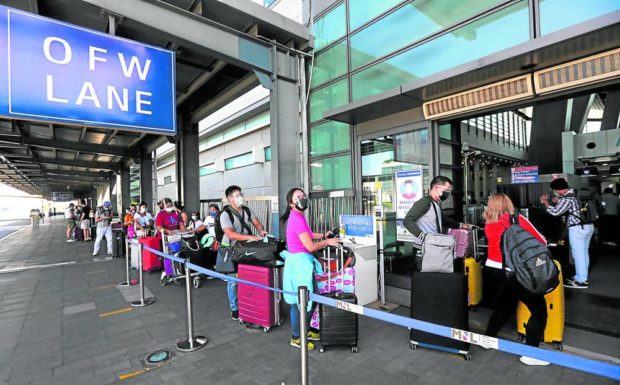 Contracted workers queue up on a special lane at Ninoy Aquino International Airport in this 2021 file photo