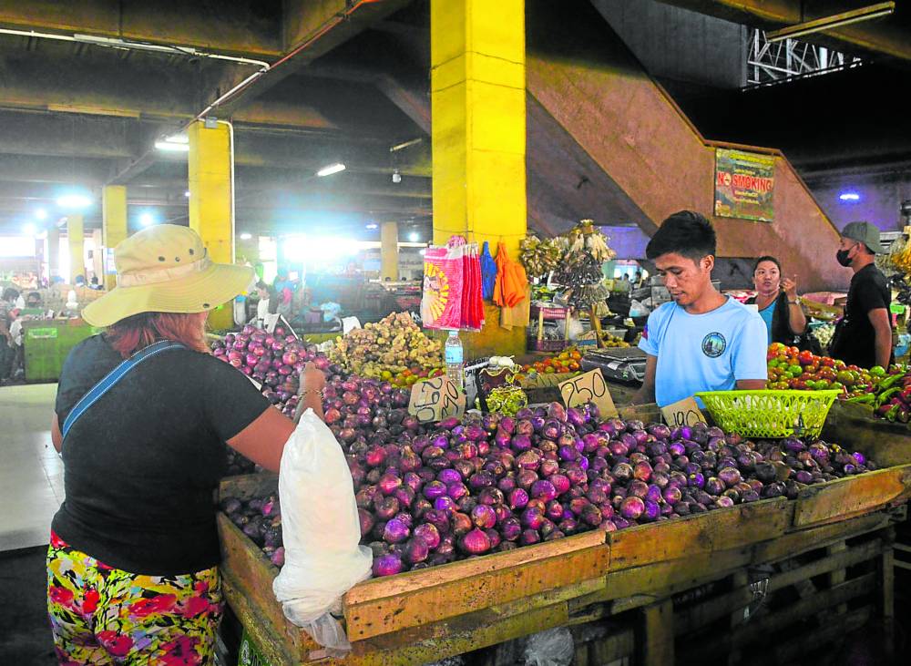 A vendor at Cogon public market in Cagayan deOro City entertains a customer in this photo taken in December last year, when onions are cheaper at P190 to P290 per kilo.