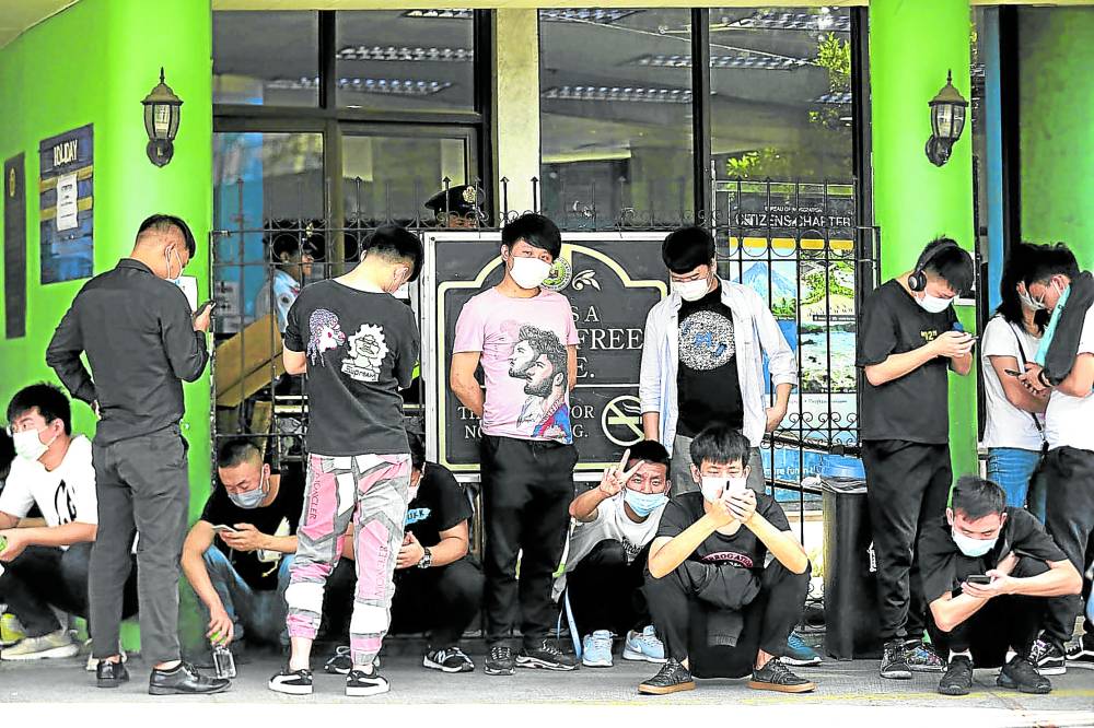 File photo shows offshore gaming firm workers outside their office in Manila
