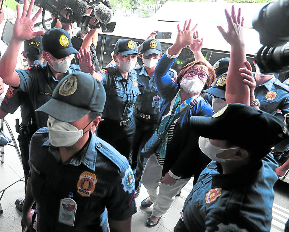 Former Sen. Leila de Lima arrives on Friday at the Muntinlupa Regional Trial Court, which is hearing the remaining two drug charges against her