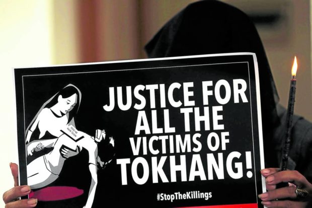 Protester holding sign says: “Justice for all the victims of Tokhang.” STORY: Congress blocs push cooperation with ICC