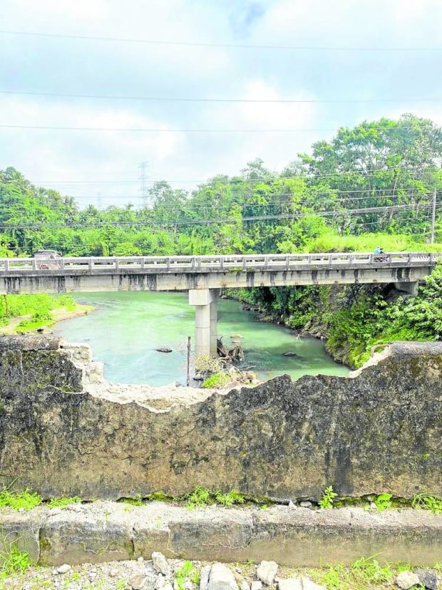 This section of the centuries-old Puente de Malagonlong, a national cultural treasure and a tourist attraction in Tayabas City in Quezon province, is found on Monday damaged by vandals, probably with the use of a sledgehammer. PHOTO COURTESY OF THE TAYABAS CITY GOVERNMENT
