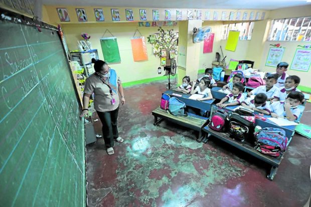 Teacher at the board in a classroom with students. STORY: VP Duterte’s education report ignored pay hike calls – teachers