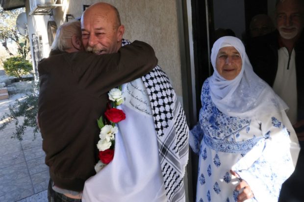 Arab Israeli Maher Younes stands next to his mother (R) as he is welcomed by friends and relatives following his release after 40 years in an Israeli prison for kidnapping and murdering an Israeli soldier, on January 19, 2023, in the northern Israeli town of Arara. (Photo by AHMAD GHARABLI / AFP)