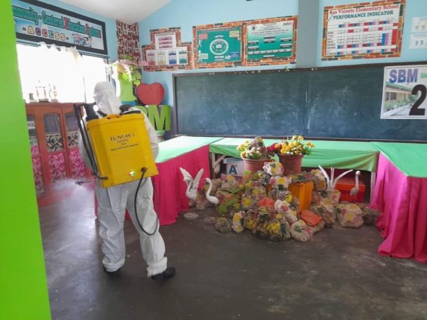 A field worker of the municipal disaster risk reduction and management office of Banga, South Cotabato conducts disinfection in public schools after the outbreak of hand, foot and mouth disease. CONTRIBUTED PHOTOS BY DEPED-BANGA