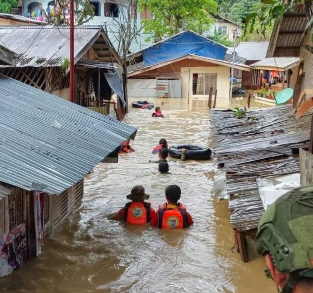Rescuers brave chest-deep waters in Barangay Cabatangan to evacuate residents at the height of the heavy rains on Tuesday. Photo by Zamboanga CDRRMO