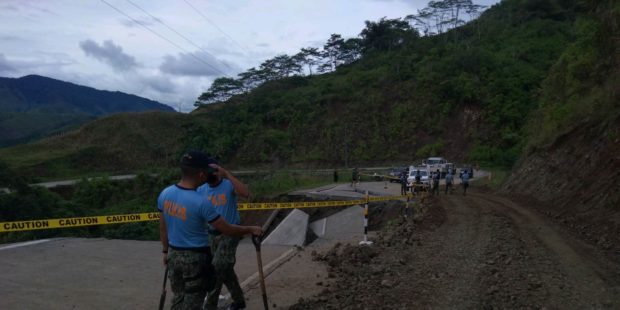 Police personnel help pave a cleared portion of a mountain to make the road passable to light vehicles. STORY: Davao del Norte-Bukidnon road open to light vehicles only