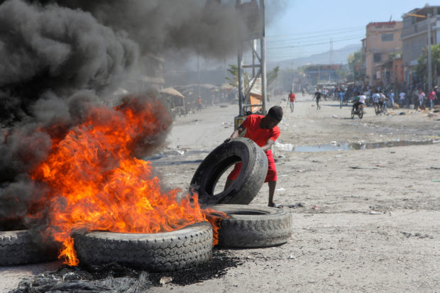 FILE PHOTO: Demonstrators protest the recent killings of police officers by armed gangs, in Port-au-Prince