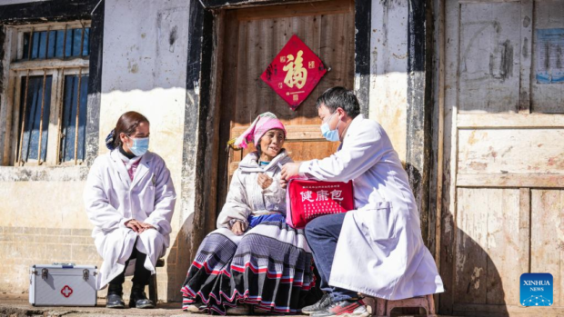 Medical workers send medicines to villagers in Shuangtang village 