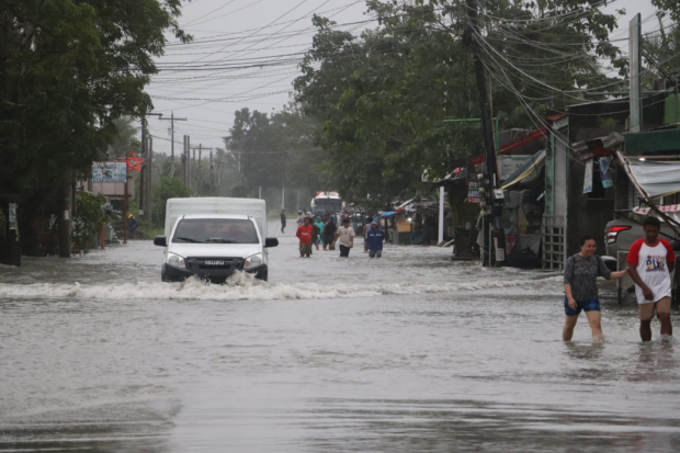 The road at Barangay Pinagsabangan II Curva in Naujan town, Oriental Mindoro is submerged in floodwater in this photo taken on Jan. 21. (Photo courtesy of Naujan MDRRMO)