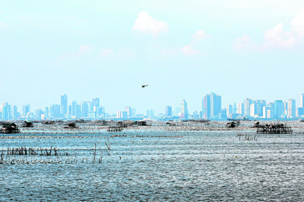 Manila Bay with faraway buildings. STORY: Water quality in Manila Bay has improved – DENR