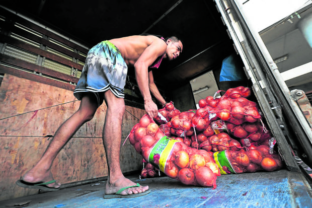 Man unloading onions from a truck. STORY: Bongbong Marcos on staying on as agri chief: ‘They cannot say no’ 