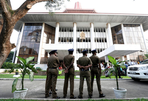 Sri Lankan Police stand guard in front of the Supreme Court in Colombo