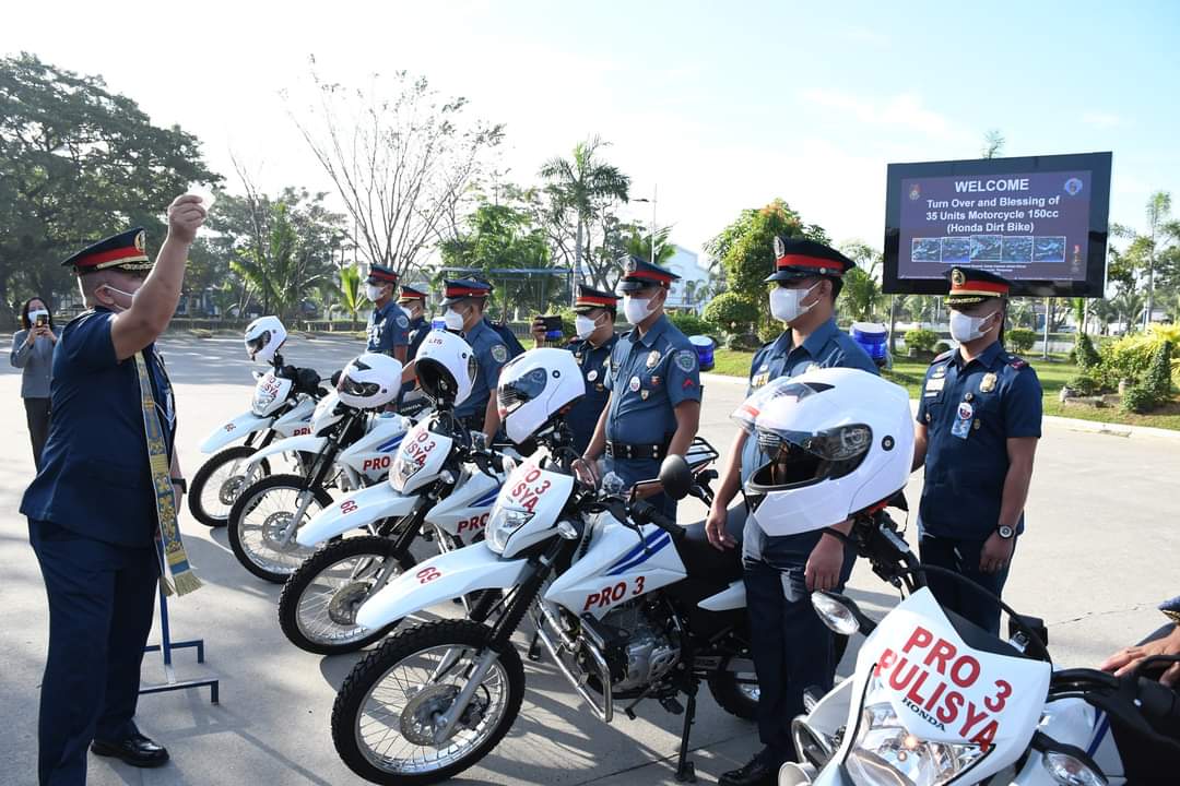 A police chaplain blesses the new all-terrain motorcycles at Camp Julian Olivas in Pampanga province. 