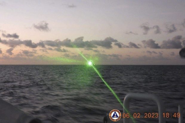 This handout photo taken on February 6, 2023 and released by the Philippine Coast Guard on February 13 shows a Chinese Coast Guard vessel shining a "military grade laser light" at a Philippine Coast Guard boat nearly 20 kilometres (12 miles) from Second Thomas Shoal, in the Spratly Islands in the disputed South China Sea. - The Philippine Coast Guard on February 13 accused a Chinese vessel of shining a "military-grade laser light" at one of its boats in the disputed South China Sea, temporarily blinding members of the crew. (Photo by Handout / Philippine Coast Guard (PCG) / AFP) / -----EDITORS NOTE --- RESTRICTED TO EDITORIAL USE - MANDATORY CREDIT "AFP PHOTO / PHILIPPINE COAST GUARD " - NO MARKETING - NO ADVERTISING CAMPAIGNS - DISTRIBUTED AS A SERVICE TO CLIENTS