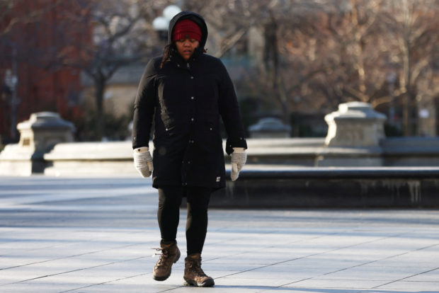 A woman walks through Washington Square Park in Manhattan as bitter cold temperatures moved into much of the northeast United States in New York City, New York, U.S., February 3, 2023. REUTERS/Mike Segar