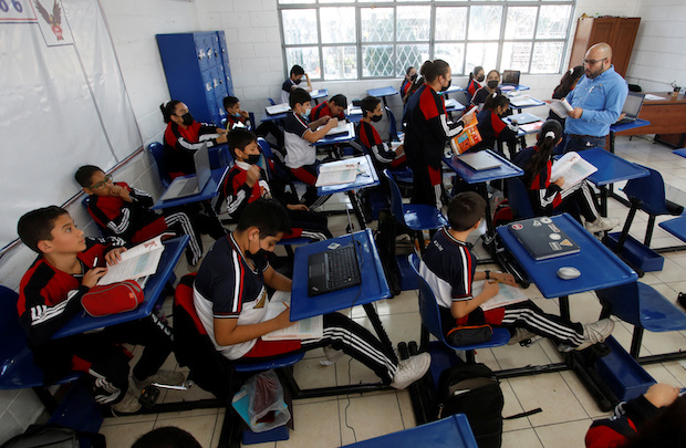 High school students pedal on a bike desk for health, during classes, in San Nicolas de los Garza. STORY: Bike desks help Mexican students learn while burning calories