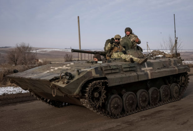 Ukrainian service members ride a BMP-2 infantry fighting vehicle, as Russia's attack on Ukraine continues, near the frontline town of Bakhmut, Donetsk region, Ukraine February 9, 2023.  REUTERS/Yevhen Titov