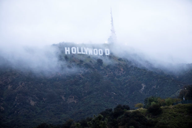 The Hollywood sign is seen through clouds during rare cold winter weather, in Los Angeles, California, U.S., February 24, 2023. REUTERS/Aude Guerrucci