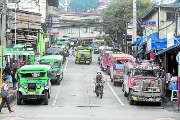 Jeepneys parked on sides of road. STORY: LTFRB extends franchise of traditional jeepneys
