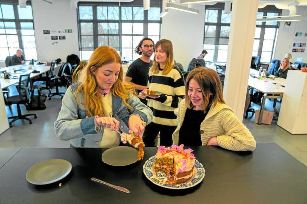 British advertising strategist and baking enthusiast Katie Mulligan brings cake to the office and shares it with colleagues in London. STORY: Britain office cake habit thrives despite warning