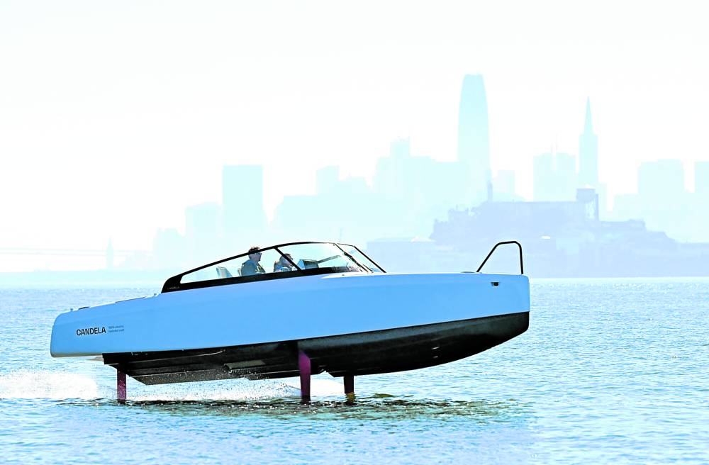 Alcatraz Island and the San Francisco skyline are seen in the horizon as French sailor Tanguy de Lamotte, CEO of Candela US, drives the company’s “flying” electric C8 boat in San Francisco Bay, California