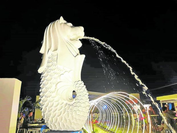 ATTENTION GETTER A replica of Singapore's famous icon, the Merlion, now stands in front of a restaurant in Cebu City's Carbon Market, built by the establishment's owner to support Mayor Michael Rama's aspiration for a "Singapore-like" city. The structure, unveiled on Feb. 13, is now turning into another attraction in the city.  PHOTO COURTESY OF JED ARIES YU 